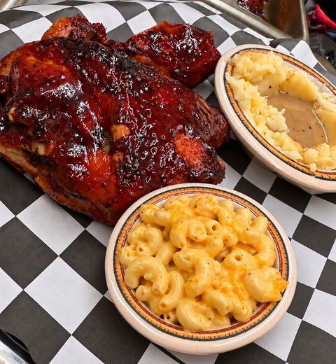 Glazed barbecue chicken with macaroni and cheese and mashed potatoes with gravy, on checkered paper